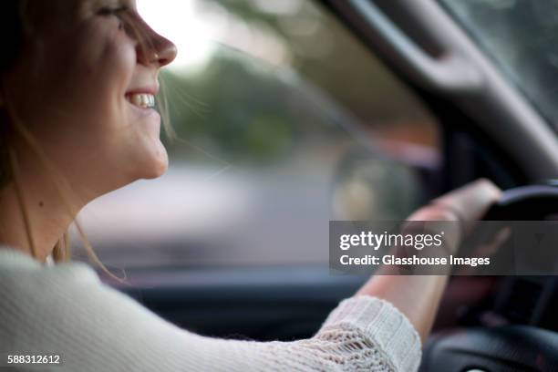 smiling teenage girl driving car - young driver stock pictures, royalty-free photos & images