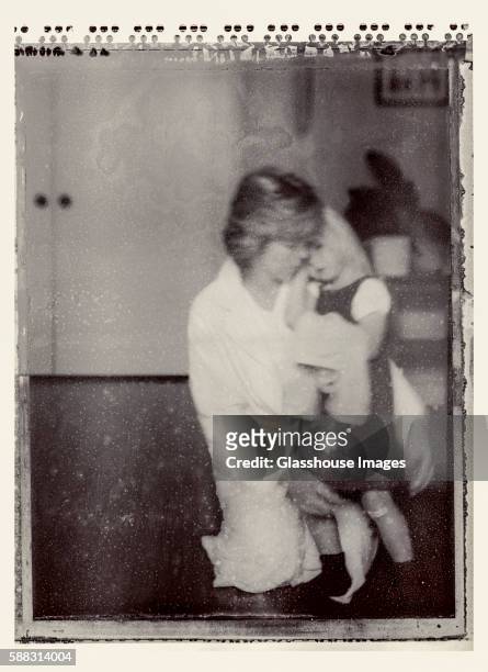 portrait of kneeling mother comforting young daughter, polaroid - vintage mother and child stock pictures, royalty-free photos & images
