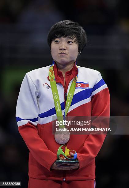 North Korea's Kim Song I poses with her bronze medal in the women's singles table tennis at the Riocentro venue during the Rio 2016 Olympic Games in...