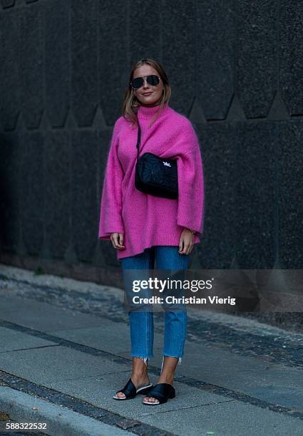 Guest wearing a pink sweater outside Lala Berlin during the first day of the Copenhagen Fashion Week Spring/Summer 2017 on August 10, 2016 in...