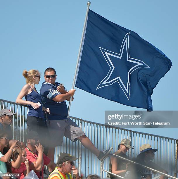 Dallas Cowboys fans bring their blue and white Cowboys Star flag during the afternoon practice at the team's training camp in Oxnard, Calif., on...