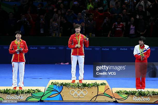 Silver medalist Li Xiaoxia of China, gold medalist Ding Ning of China and bronze medalist Kim Song I of North Korea pose on the podium after the...