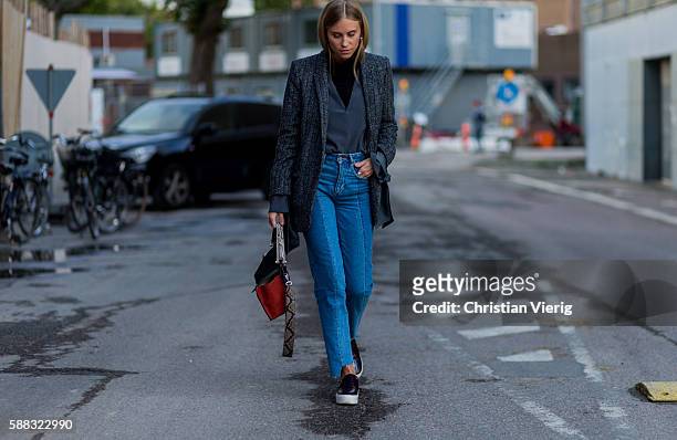 Tine Andrea wearing a grey jacket, denim jeans and a black Fendi bag outside Lala Berlin during the first day of the Copenhagen Fashion Week...