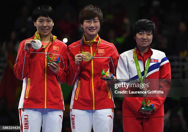 L-r Silver medalist Li Xiaoxia, Gold medalist Ning Ding of China and Bronze medalist I Song Kim of Democratic Peoples Republic of Korea pose during...