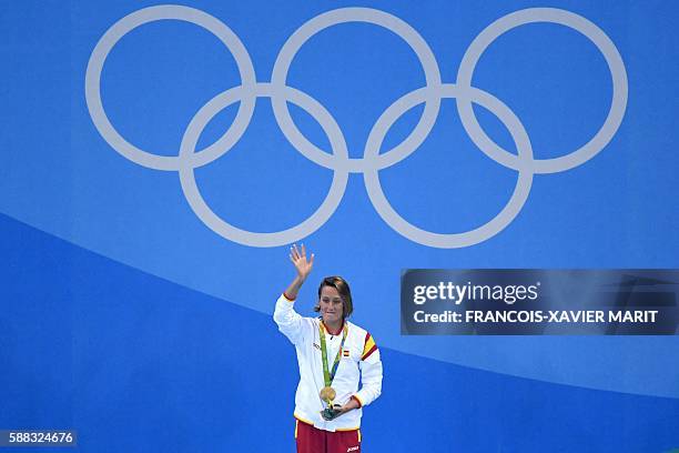 Spain's Mireia Belmonte Garcia poses on the podium with her gold medal after she won the Women's 200m Butterfly Final during the swimming event at...