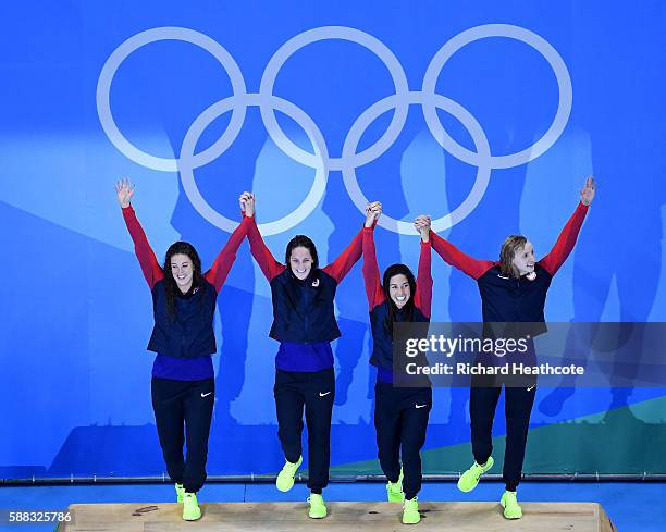 Allison Schmitt, Leah Smith, Maya Dirado and Katie Ledecky of the United States pose on the podium during the medal ceremony for the Women's 4 x 200m...