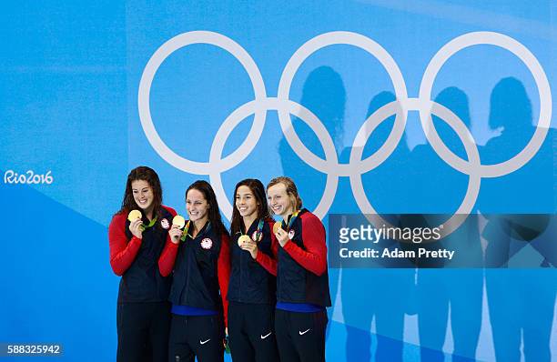 Gold medalists Allison Schmitt, Leah Smith, Maya Dirado and Katie Ledecky of the United States pose on the podium during the medal ceremony for the...