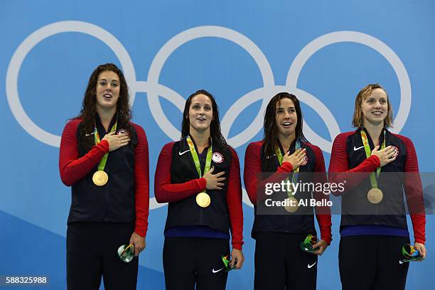 Gold medalists Allison Schmitt, Leah Smith, Maya Dirado and Katie Ledecky of the United States pose on the podium during the medal ceremony for the...