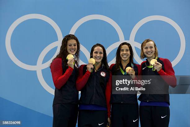 Gold medalists Allison Schmitt, Leah Smith, Maya Dirado and Katie Ledecky of the United States pose on the podium during the medal ceremony for the...