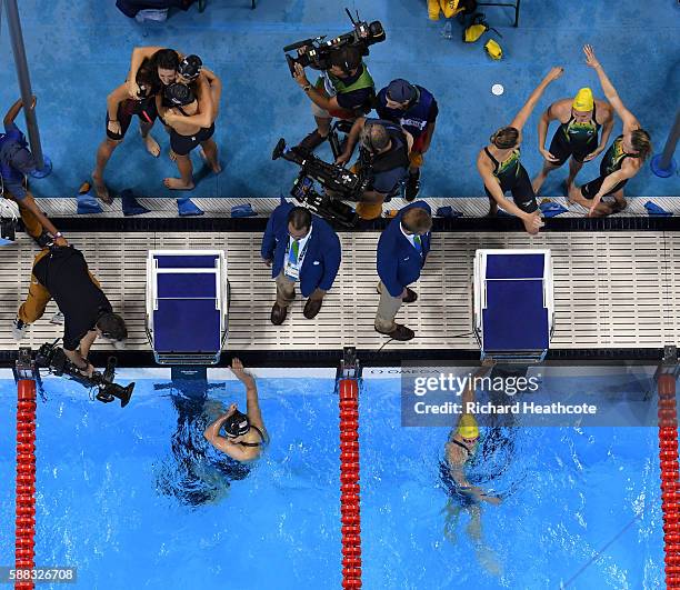 Team United States celebrate winning gold as Team Australia celebrate silver in the Women's 4 x 200m Freestyle Relay Final on Day 5 of the Rio 2016...