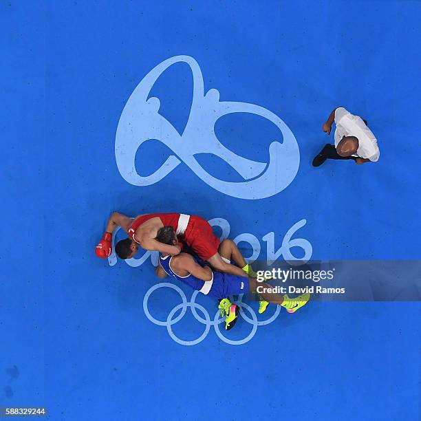 Evgeny Tishchenko of Russia and Clemente Russo of Italy compete in the Men's Heavy quarterfinals round fight on Day 5 of the Rio 2016 Olympic Games...