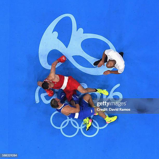 Evgeny Tishchenko of Russia and Clemente Russo of Italy compete in the Men's Heavy quarterfinals round fight on Day 5 of the Rio 2016 Olympic Games...