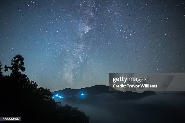 the milky way hangs about a valley filled with fog - okayama prefecture stock pictures, royalty-free photos & images