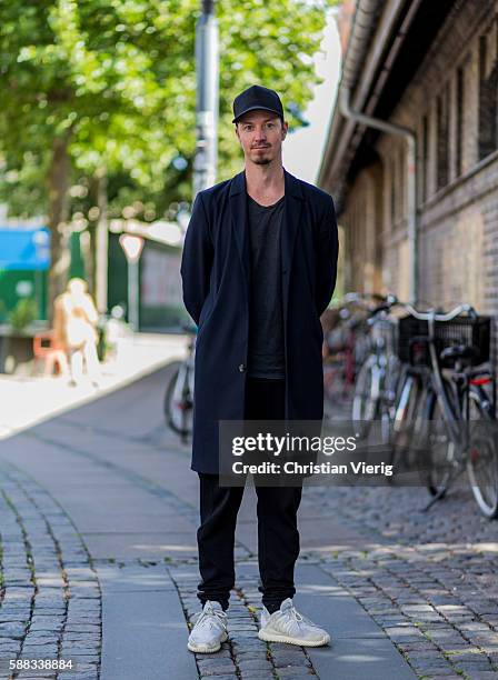 Caspar Schandorff wearing a black cap, coat, grey tshirt, black jogger pants grey sneakers outside Revolver Fair during the first day of the...