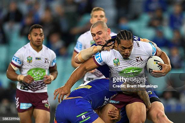 Martin Taupau of Manly is tackled during the round 23 NRL match between the Canterbury Bulldogs and the Manly Sea Eagles at ANZ Stadium on August 11,...