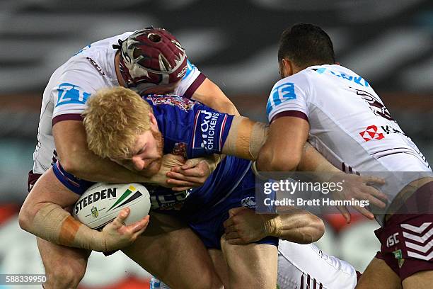 James Graham of the Bulldogs is tackled during the round 23 NRL match between the Canterbury Bulldogs and the Manly Sea Eagles at ANZ Stadium on...