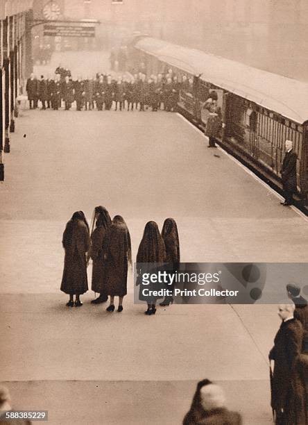Lone group of royal mourners: Queen Mary with the Princess Royal and her daughters-in-law, after the departure of the coffin, waiting at King's Cross...