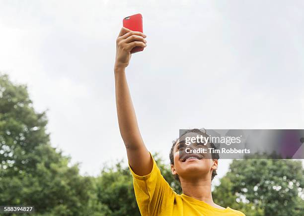 woman with smart phone in air. - holding above head stock pictures, royalty-free photos & images