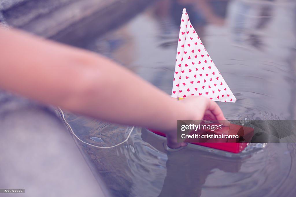 Girl playing with a boat