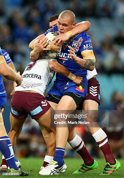 David Klemmer of the Bulldogs is tackled during the round 23 NRL match between the Canterbury Bulldogs and the Manly Sea Eagles at ANZ Stadium on...