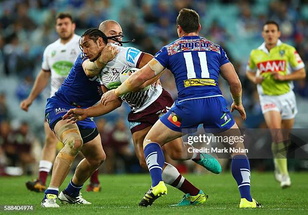 Martin Taupau of the Eagles is tackled high during the round 23 NRL match between the Canterbury Bulldogs and the Manly Sea Eagles at ANZ Stadium on...