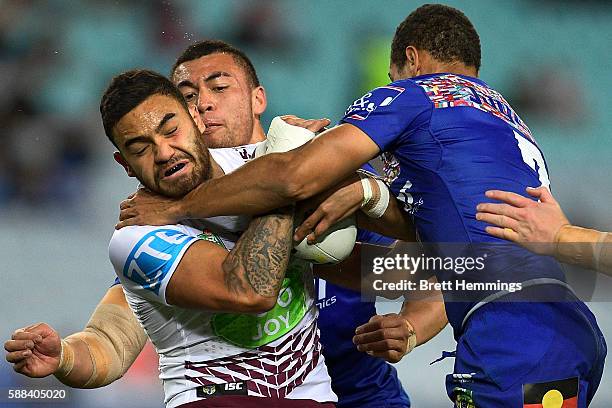 Dylan Walker of Manly is tackled during the round 23 NRL match between the Canterbury Bulldogs and the Manly Sea Eagles at ANZ Stadium on August 11,...