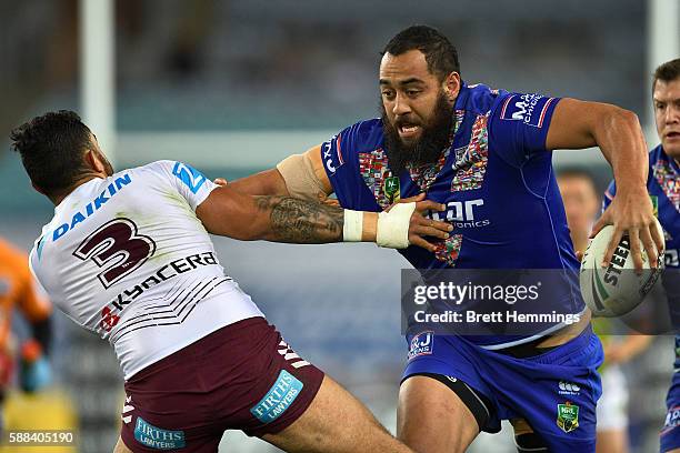 Sam Kasiano of the Bulldogs palms off Dylan Walker of Manly during the round 23 NRL match between the Canterbury Bulldogs and the Manly Sea Eagles at...