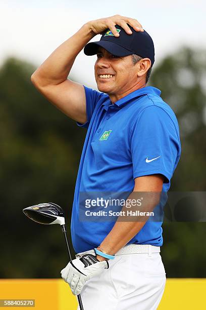 Adilson da Silva of Brazil reacts to his shot from the third tee during the first round of men's golf on Day 6 of the Rio 2016 Olympics at the...