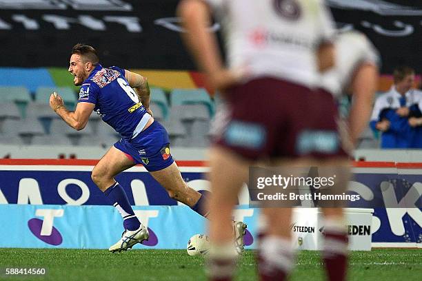 Josh Reynolds of the Bulldogs celebrates scoring a try to win the match during the round 23 NRL match between the Canterbury Bulldogs and the Manly...