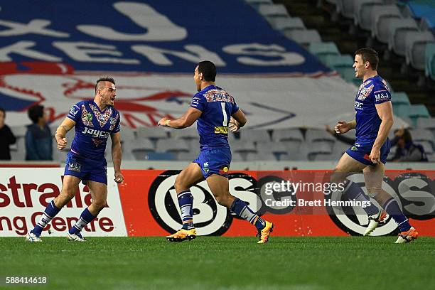 Josh Reynolds of the Bulldogs celebrates scoring a try to win the match during the round 23 NRL match between the Canterbury Bulldogs and the Manly...