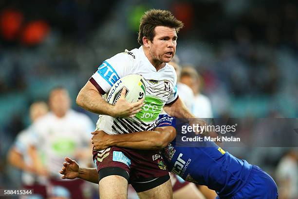 Jamie Lyon of the Eagles is tackled during the round 23 NRL match between the Canterbury Bulldogs and the Manly Sea Eagles at ANZ Stadium on August...