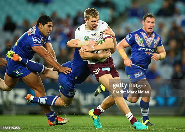 Tom Trbojevic of the Eagles is tackled during the round 23 NRL match between the Canterbury Bulldogs and the Manly Sea Eagles at ANZ Stadium on...