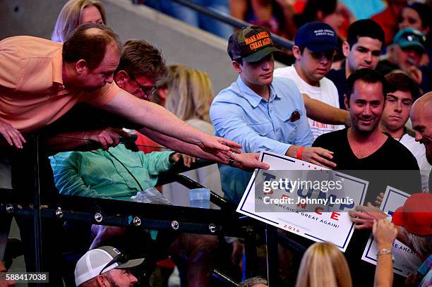 People cheer as Republican presidential nominee Donald Trump speaks during his campaign event at the BB&T Center on August 10, 2016 in Sunrise,...