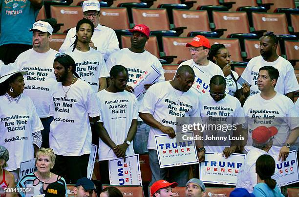 People cheer as Republican presidential nominee Donald Trump speaks during his campaign event at the BB&T Center on August 10, 2016 in Sunrise,...