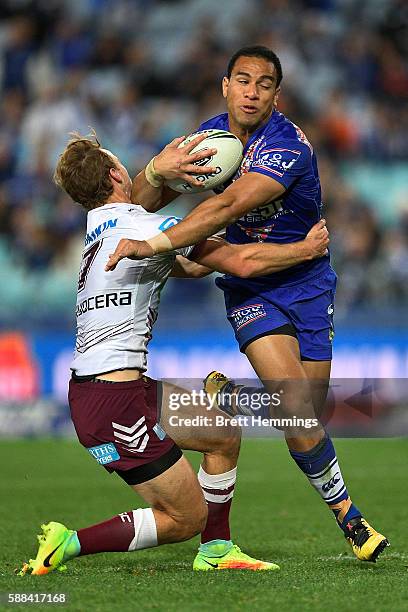 William Hopoate of the Bulldogs is tackled by Daly Cherry-Evans of Manly during the round 23 NRL match between the Canterbury Bulldogs and the Manly...