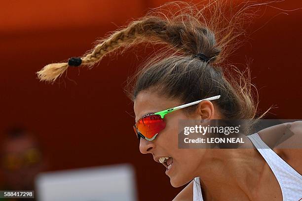 Poland's Monika Brzostek is seen as she and teammate Kinga Kolosinska return the ball to Brazil's Larissa Franca Maestrini and Talita Rocha during...