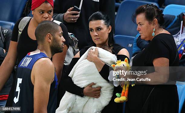 Nicolas Batum of France meets Aurelie and their 7 months old baby son Ayden Richard Batum following the men's basketball match between France and...