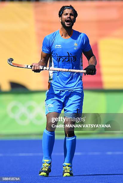 India's Rupinder Pal Singh shouts during the men's field hockey Netherland's vs India match of the Rio 2016 Olympics Games at the Olympic Hockey...