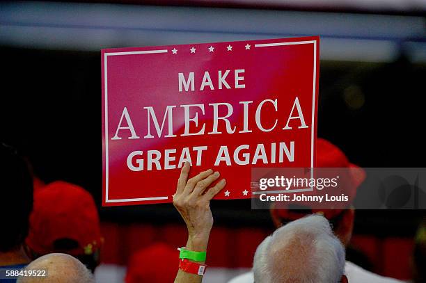 People cheer as Republican presidential nominee Donald Trump speaks during his campaign event at the BB&T Center on August 10, 2016 in Sunrise,...