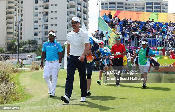 Henrik Stenson of Sweden, Thongchai Jaidee of Thailand and Rafa Cabrera Bello of Spain walk from the first tee during the first round of men's golf...