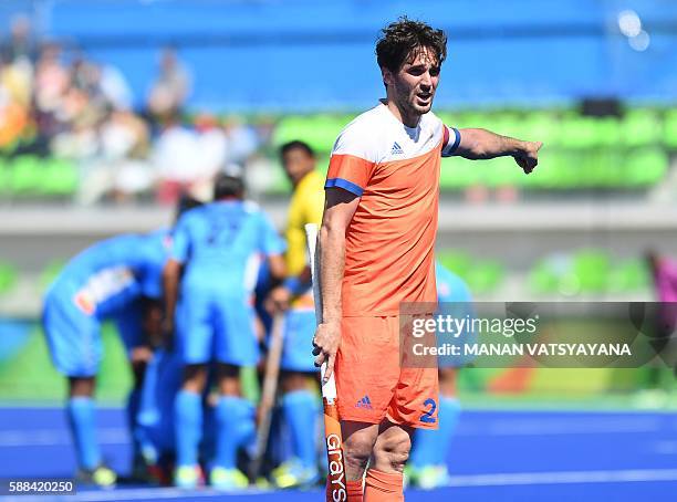 Netherland's Robert van der Horst gestures during the men's field hockey Netherland's vs India match of the Rio 2016 Olympics Games at the Olympic...