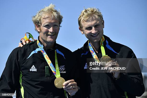 New Zealand's Eric Murray and New Zealand's Hamish Bond celebrate with their gold medals on the podium of Men's Pair final rowing competition at the...