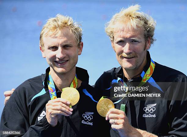 New Zealand's Eric Murray and New Zealand's Hamish Bond celebrate with their gold medals on the podium of Men's Pair final rowing competition at the...