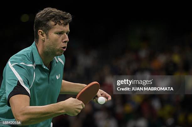 Belarus' Vladimir Samsonov serves against China's Zhang Jike in their men's singles semi-final table tennis match at the Riocentro venue during the...