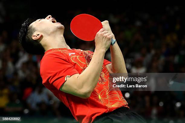 Ma Long of China celebrates after winning his Mens Table Tennis Singles Semifinal match against Jun Mizutani of Japan at Rio Centro on August 11,...