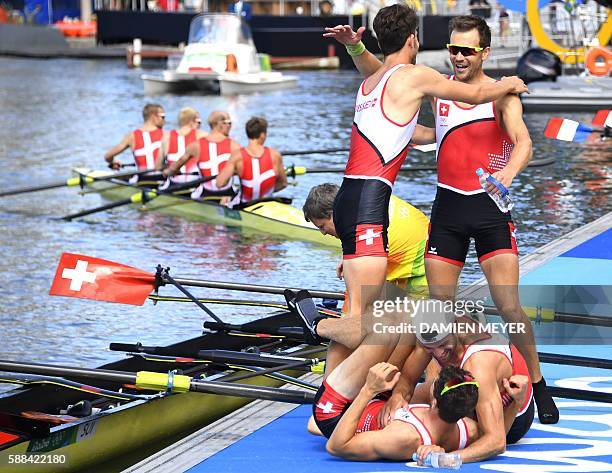 Switzerland's Mario Gyr, Switzerland's Simon Schuerch, Switzerland's Simon Niepmann and Switzerland's Lucas Tramer celebrate at the end of the LWT...