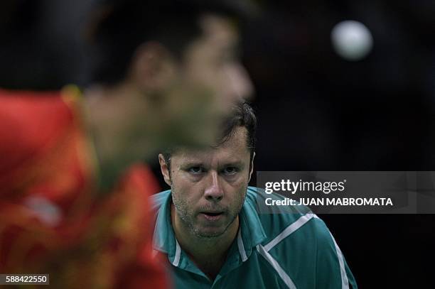 China's Zhang Jike serves against Belarus' Vladimir Samsonov in their men's singles semi-final table tennis match at the Riocentro venue during the...