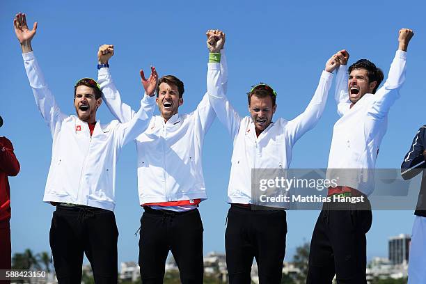 Lucas Tramer of Switzerland, Simon Schuerch of Switzerland, Simon Niepmann of Switzerland and Mario Gyr of Switzerland celebrate winning gold in the...