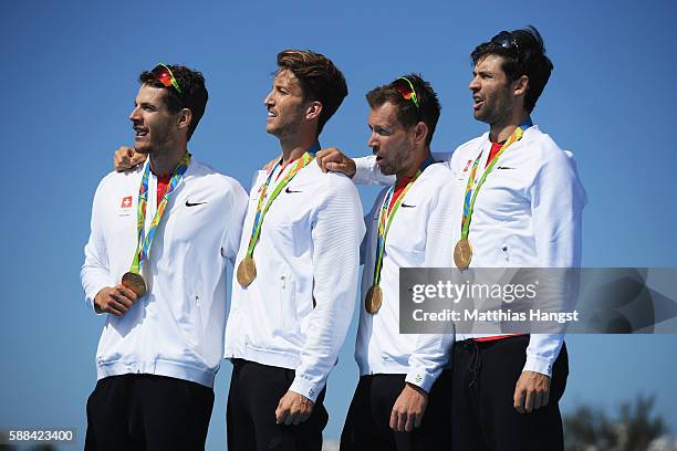 Lucas Tramer of Switzerland, Simon Schuerch of Switzerland, Simon Niepmann of Switzerland and Mario Gyr of Switzerland celebrate winning gold in the...