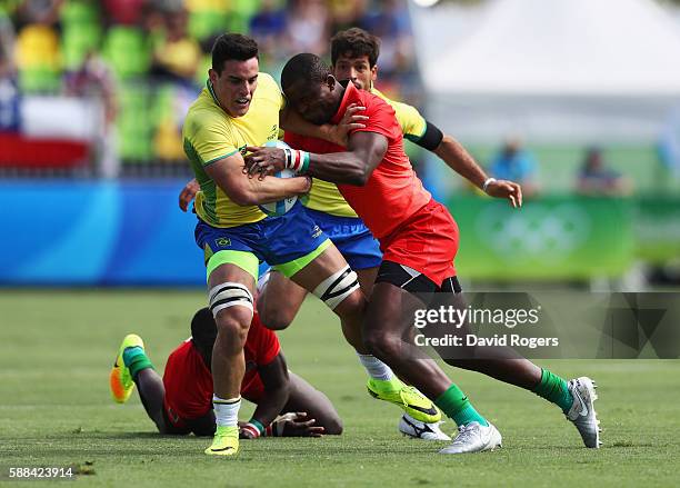 Felipe Sancery of Brazil is tackled by Willie Ambaka of Kenya during the Men's Rugby Sevens placing 11-12 match between Brazil and Kenya on Day 6 of...